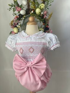 Pre-order handmade smocked romper. It takes 3-6 weeks to ship. Thank you for your patience. Thank you for supporting a small business. Clothing Care Instructions Most items can be washed safely in cold water on delicate cycle and hung to dry. If the item that you are ordering has red or another bright color in it next to a white or other light color fabric please use a Shout color catcher for the first few washes to avoid bleeding. The reds are pre-washed but they are still red and will likely h Cute Pink Bubble Romper With Smocked Bodice, Cute Pink Bubble Romper With Smocked Back, Spring Bubble Romper With Smock Detail, Spring Fitted Smocked Bubble Romper, Spring Fitted Smock Bubble Romper, Cotton Fitted Bubble Romper With Smocked Back, Fitted Smock Bubble Romper For Summer, Cute White Bubble Romper With Smocked Back, Cute White Bubble Romper With Smocked Bodice