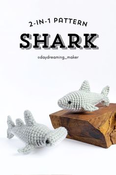 two crocheted shark figures sitting on top of a wooden block with text overlay that reads, 2 - in - 1 pattern shark