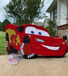 a cardboard car that is sitting on the ground