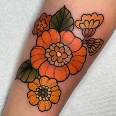 an orange flower tattoo on the leg