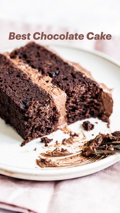 a piece of chocolate cake on a white plate with a fork next to the slice