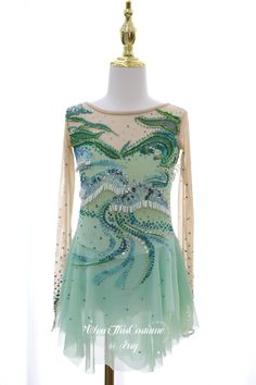 a dress on a mannequin with beads and sequins in the center