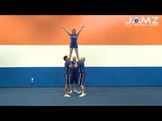 a group of young people standing on top of a blue and white tennis court with their arms in the air