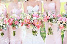 a group of bridesmaids holding bouquets of pink and white flowers in their hands