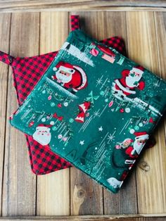 two christmas themed napkins sitting on top of a wooden table