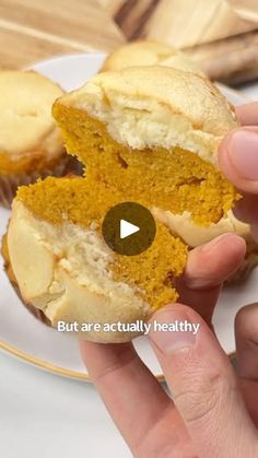 a person holding a half eaten pumpkin cupcake on a white plate with the words, but are actually healthy