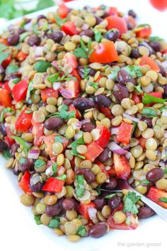 a white plate topped with beans and veggies