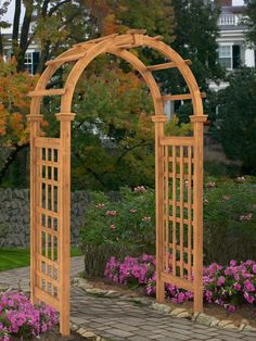 an arched wooden garden arbor with potted plants