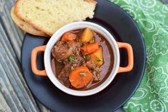 a bowl of stew with bread on the side