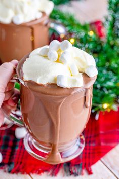 two mugs filled with hot chocolate and marshmallows