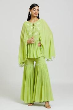 Green georgette kaftan with beads and mirror embroidered circles. Comes with gharara.
Components: 2
Pattern: Embroidered
Type Of Work: Beads, Mirror
Neckline: Round
Sleeve Type: Flared Sleeves
Fabric: Georgette
Color: Green
Other Details: 
Attached lining
Length:
Kaftan: 29 inches
Gharara: 43 inches
Closure:
Kaftan - Front tie-up
Gharara: Side zip
Occasion: Sangeet - Aza Fashions Embroidered Circles, Georgette Kaftan, Kaftan Pattern, Embroidered Beads, Types Of Work, Beaded Neckline, Green Beads, Set For Women, Flared Sleeves