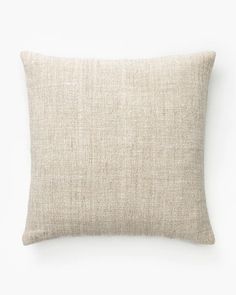 a beige pillow on a white background