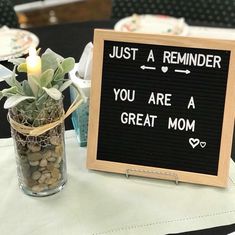 a sign that says just a reminder you are a great mom next to a potted plant