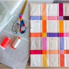 sewing supplies are laid out on the table next to each other, including scissors and thread