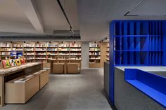 the interior of a library with blue shelves and bookshelves filled with colorful books