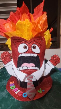 a red paper mask with yellow and orange hair