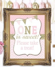 one is sweet please take a treat sign with tassels and pink flowers on the table