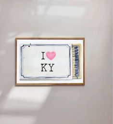 an i love ky sign is hanging on the wall next to a toothbrush holder