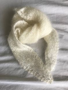 This luxurious silky soft lightweight scarf is hand knit by me, made with 30% silk and 70% mohiar. The pattern is my own design with an eyelet effect around the edges. A perfect accessory to wear for any occasion in any season. This scarf measures 55cm long by 20cm wide at the middle point. This item is ready to ship! Care instructions: Cool hand wash if absolutely necessary. To deodorise, place garment outside in a safe place to bask in fresh air. Dry flat on towel or across clothes airer. Pill Handmade Cream Shawl One Size, White Hand Knitted Scarf One Size, Handmade Mohair Shawl Scarf, Cream Knitted Shawl One Size, One Size Cream Knitted Shawl, White Hand Knitted Scarf, Cream Knitted One Size Shawl, Hand Knitted Alpaca Scarves, Mohair Accessories