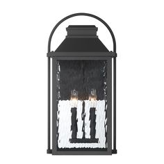 a black lantern with three candles on it