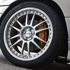 the front wheel of a silver sports car