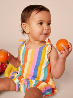 This striped romper is pure summer joy! Inspired by the breathtaking beauty of Kenya's Lamu Island, our artists went all out with brilliant and bold stripes. This warm-weather romper is a customer favorite thanks to the lightweight and breathable 100% soft cotton jersey that will keep its color and shape, wash after wash. Features adjustable shoulder ties, inseam snaps, and elastic leg openings for easy dressing and diaper changes. Falls at mid-thigh. Matching family styles are available in our Dress Romper Outfit, Lamu Island, Swim Toys, Clothing Catalog, Breathtaking Beauty, Romper Outfit, Easy Dressing, Outerwear Outfit, Bold Stripes