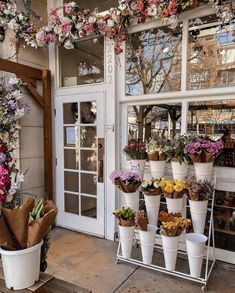 a flower shop with lots of flowers on display