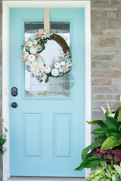 a blue front door with a wreath on it