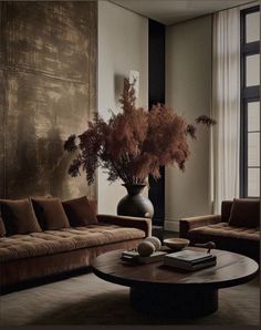 a living room filled with furniture and a large vase on top of a coffee table