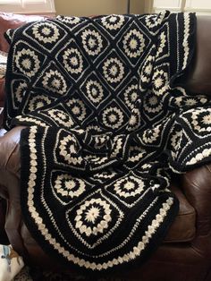 a black and white afghan sitting on top of a couch