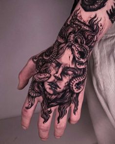 a person's hand with a tattoo on it