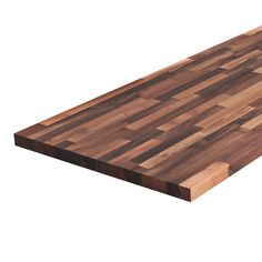 a large wooden cutting board sitting on top of a white surface with no one around it