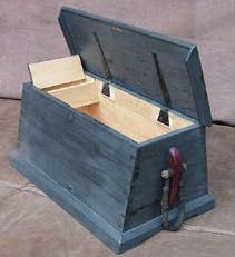 an open wooden box sitting on the ground