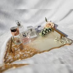 an assortment of perfumes sitting on top of a tray