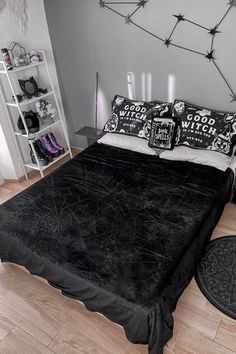 a black and white bedroom with candles on the wall