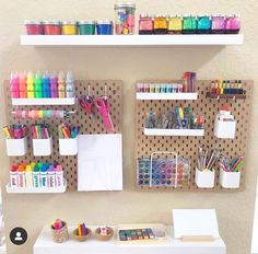 the wall is filled with craft supplies and art supplies