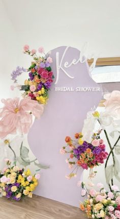 flowers on display in front of a sign for the bride's bridal shower