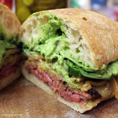 a close up of a sandwich with meat and guacamole