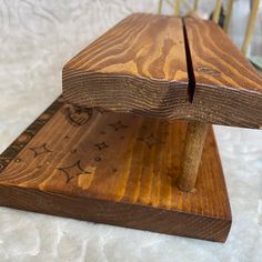 a wooden bench sitting on top of a white sheet