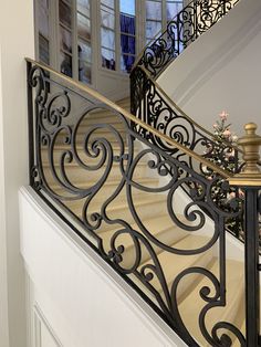 a staircase with wrought iron handrails and glass doors