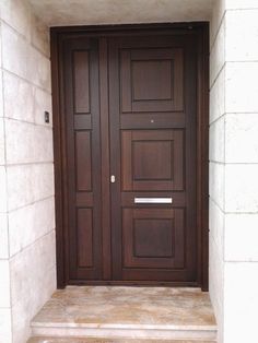 the front door is made of wood and has two sidelights