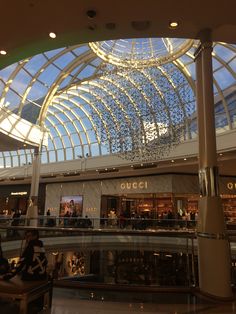 the inside of a shopping mall with people walking around