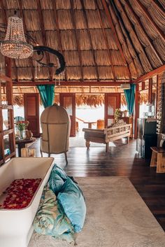 a living room filled with furniture and a large tub in the middle of an open floor plan