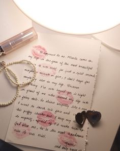 a note with two hearts on it next to a lamp