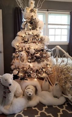 a white christmas tree decorated with teddy bears