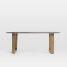 a wooden table sitting on top of a white floor