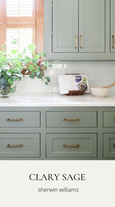 an image of a kitchen with green cabinets and white marble counter tops that says clayy sage