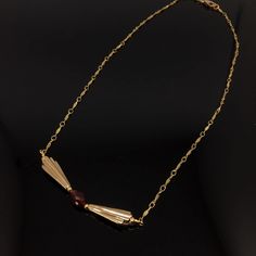 "Do you love the Art Deco design period? Do you love Garnet? Do you love wearing unique one-of-a-kind artisan jewelry? If you answered yes to these questions then this amazing necklace deserves to be yours! Lightly curved, flat, Gold Fill links are linked together in an amazing chain. From the chain are Art Deco inspired light Bronze charms in a quintessential Art Deco fan design. They are a light Bronze but look like vintage gold. In the center of the Bronze charms i a gorgeous, clear, faceted, Art Deco Gemstone Necklace For Anniversary, Vintage Red Jewelry With Adjustable Chain, Unique Ruby Necklace For Gift, Antique Ruby Gemstone Necklace, Antique Garnet Pendant Necklace, Garnet Birthstone Necklaces For Jewelry Making, Garnet Birthstone Necklace For Jewelry Making, Antique Red Garnet Necklace, Vintage Red Gemstone Necklace