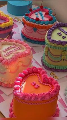 there are many colorful cakes on the table