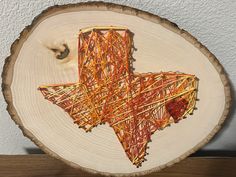 a piece of wood that has been cut into the shape of a texas state on it